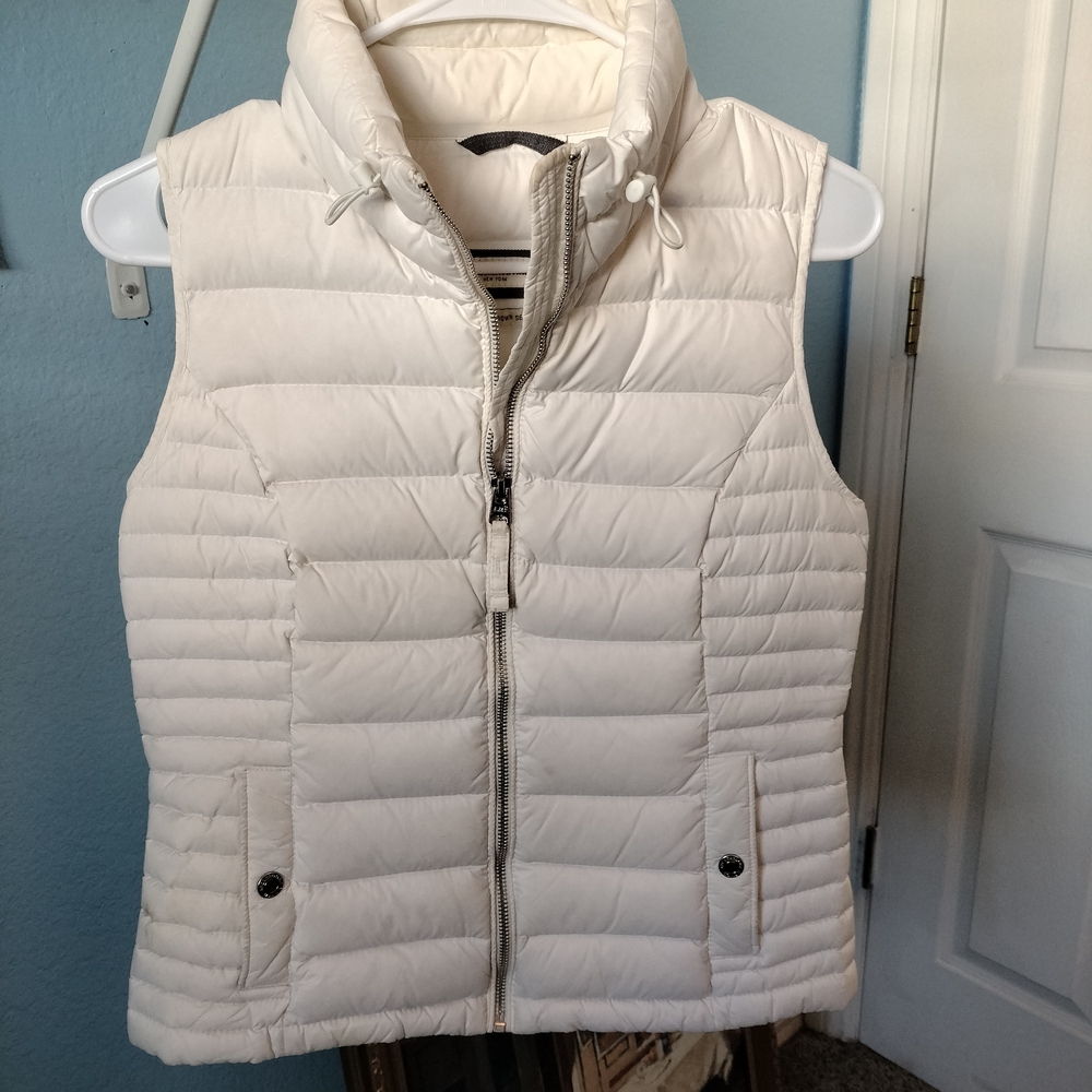 White quilted puffer vest with high collar and full-length zipper